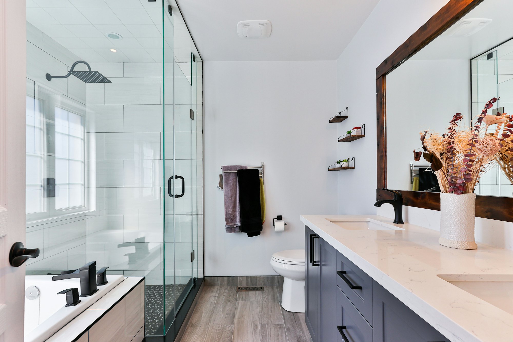 Frameless glass shower enclosure in a modern South Florida bathroom