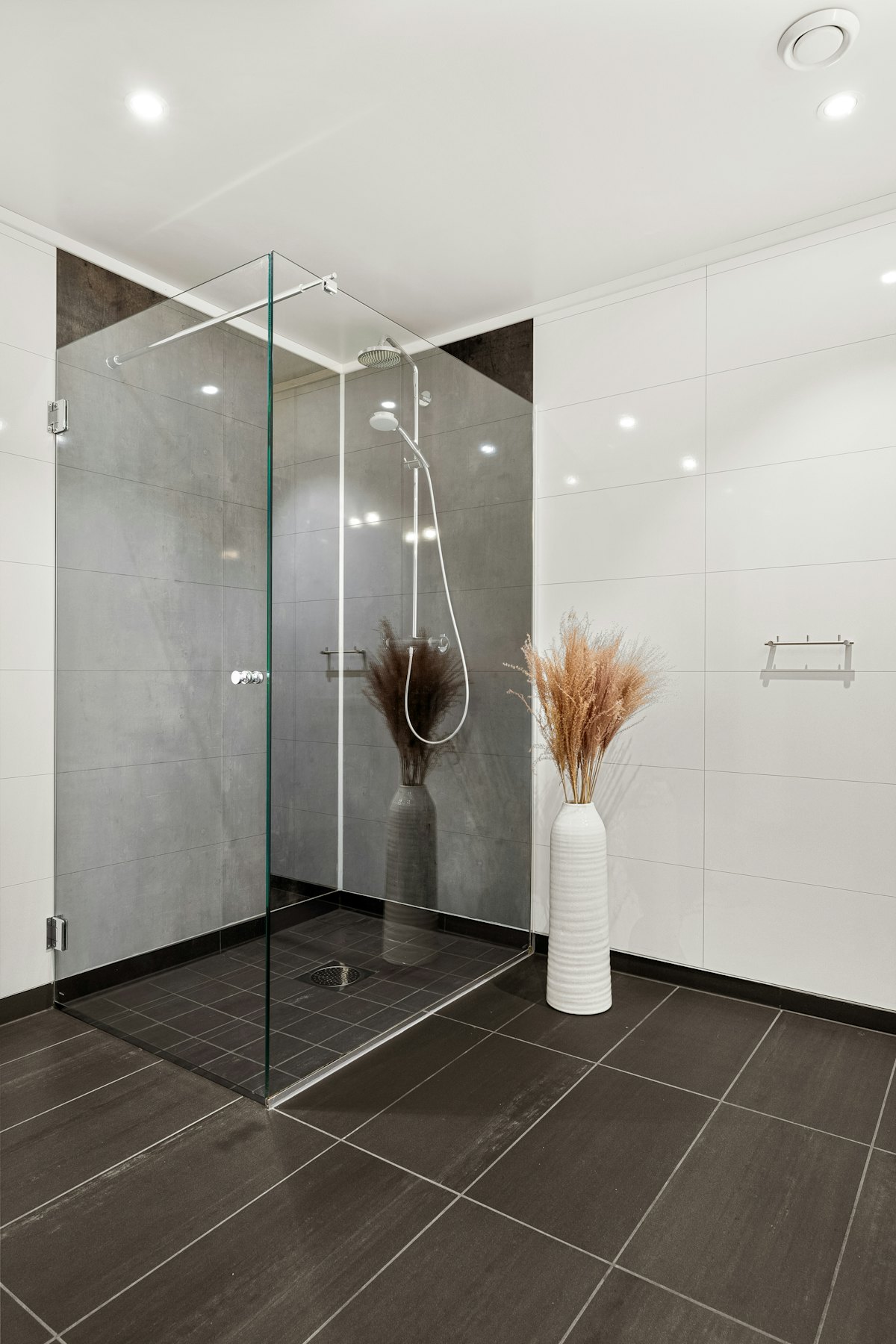 Frameless glass shower enclosure with black hardware